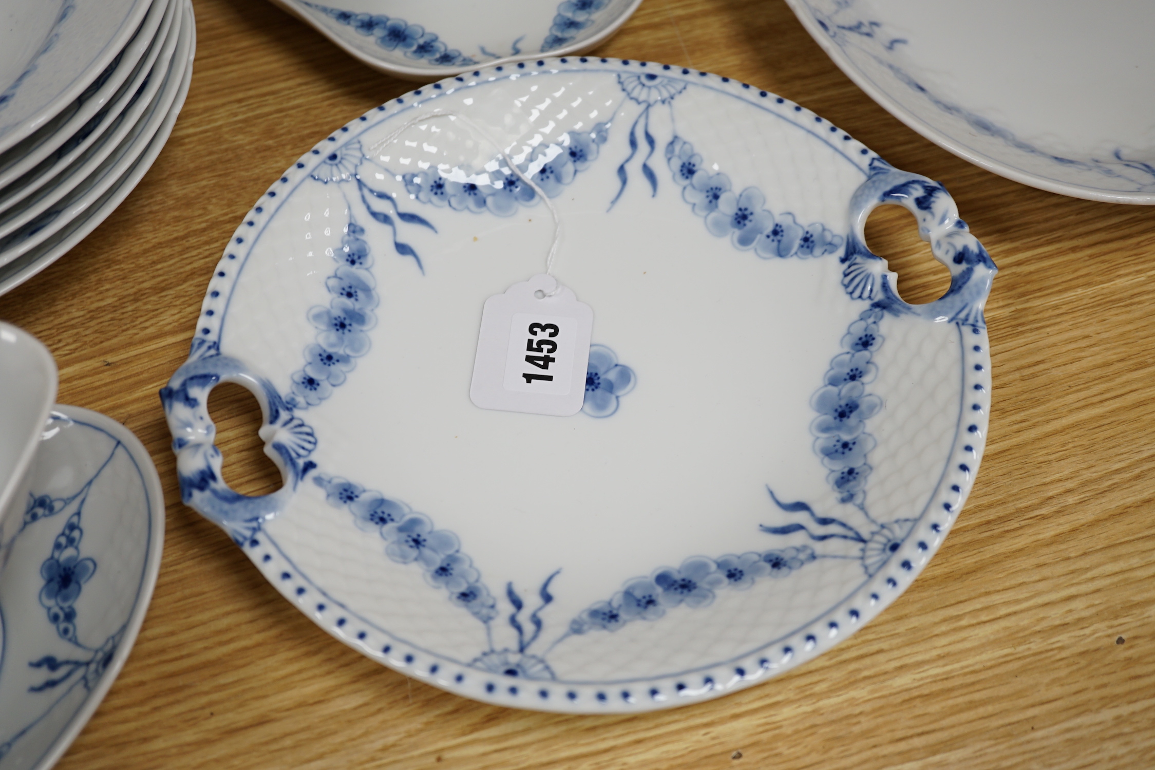 A Bing and Grondahl, Denmark blue and white ‘Empire’ pattern dinner service, thirty-eight pieces including; a cake, stand, candlestick, dinner, plates, jug, serving, dishes, etc.